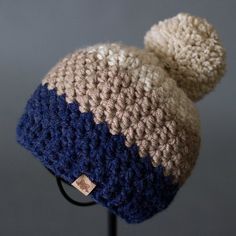 a crocheted hat with a pom - pom attached to the brim