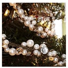 a christmas tree with white balls hanging from it's branches