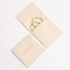 a pair of gold scissors sitting on top of a piece of white paper next to an envelope