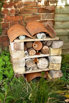 an old brick shelf with lots of pots and pans stacked on top of it