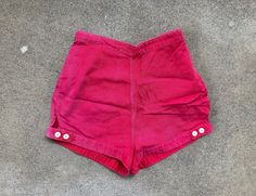 --  Vintage 50s to early 60s Bradley Red Cotton Side Zip High Waisted Shorts --  Nice condition with light wear, but look killer and have tons of life left --  100% cotton  --  Size 24 x 1 1/4 (Small), but please see below for measurements --  Thanks for looking and have a fantastic day! MEASUREMENTS Waist - 12 inches across; 24 inch waist (can also be worn with one button let out, measuring 25 inch waist) Hips - 16 1/2 inches across; 33 inch hips Rise - 13 1/4 inches Inseam - 1 1/4 inches Total Retro Red Shorts, Vintage Fitted Bottoms With Short Leg, Vintage Fitted Short Bottoms, Retro Red Short Shorts, Retro Bottoms For Summer Vintage Fashion, Vintage Fitted Shorts With Short Inseam, Retro Summer Bottoms For Vintage Fashion, Vintage Fitted Shorts With Short Legs, Vintage High Waist Fitted Shorts