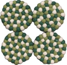 three green and white coasters sitting on top of each other in the shape of circles