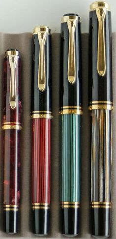 four different types of fountain pens lined up in a box