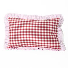 a red and white gingham pillow with ruffled edges