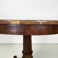 an old wooden table with a curved top