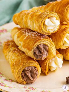 there are some croissants with chocolate filling on the top and white cream in the middle