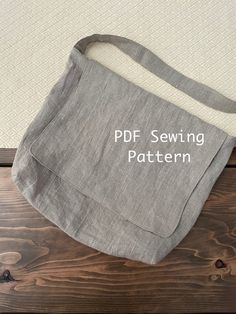 a gray bag with the words pdf sewing pattern on it sitting on top of a wooden table