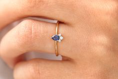 "Sapphire Ring / 14k Natural Sapphire and Diamond Engagement Ring / Genuine Blue Sapphire Promise Ring / September Birthstone Features ✔Made to Order ✔Gold Kt: 14K (also available in 18K) ✔Available Gold Color: Rose Gold, Yellow Gold, White Gold ✔Pear Shape Sapphire: 1 pc 4x3MM ✔Round Diamond: 1 pc 1.7 MM ✔Round Diamond: 2 pc2 1.3 MM ✔Number of Stones: 4 ✔Sapphire CTW: 0.25 ctw ✔Diamond CTW: 0.06 ctw ✔Ready to Ship in 7-10 Business Days If you have any additional questions about this ring, just Blue Birthstone Ring With Center Stone In 14k Gold, Blue Gemstone Dainty Ring, Dainty Blue 14k Gold Rings, Dainty Blue Gemstone Ring, Blue Birthstone Diamond Ring In 14k Gold, Blue 14k Gold Diamond Birthstone Ring, Blue 14k Gold Diamond Ring With Birthstone, Blue Birthstone Ring Stamped 14k As Gift, Blue 14k Gold Cluster Ring