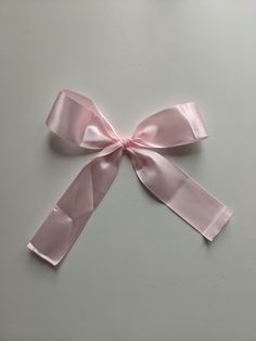 a pink ribbon tied on top of a table