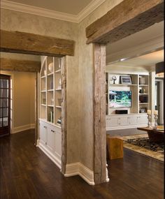 a living room filled with furniture and lots of wood flooring on top of a hard wood floor