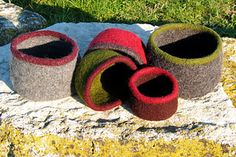 three felt pots sitting on top of a rock