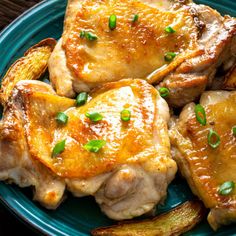 some chicken and potatoes on a blue plate