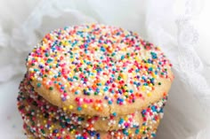 three cookies with sprinkles stacked on top of each other