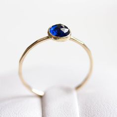 Tiny skinny stackable ring with beautiful deep blue Sapphire stone. It is made with a skinny but sturdy band, which allows you to create beautiful stacking sets! The ring is ideal for everyday wear and it will also look amazing with a festive dress.The ring is 0,8-0,9 mm thick and looks very dainty on the finger. Choose the finish of the stone (smooth cabochon or rose cut) and material for the ring (sterling silver or 9k gold).If you want to change the ring band design or get a custom ring or ri Blue Sapphire Stackable Birthstone Ring, Blue Gemstone Dainty Stackable Rings, Minimalist Sapphire Ring With Bezel Setting For Everyday, Everyday Stackable Sapphire Ring, Dainty Blue Gemstone Stackable Rings, Dainty Stackable Sapphire Ring, Dainty Stackable Sapphire Ring Gift, Sapphire Stackable Rings With Bezel Setting For Promise, Dainty Blue Sapphire Stackable Ring