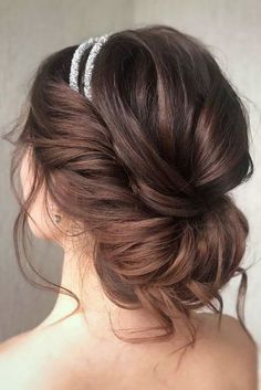 a woman with her hair in a low bun