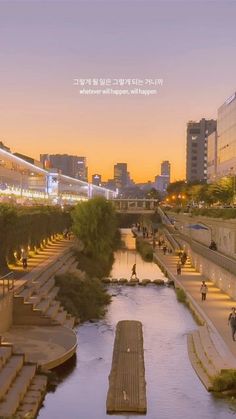 a river running through a city next to tall buildings