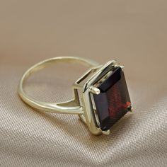 Super elegant solitaire ring set with a large natural Garnet gemstone. This Rich red garnet makes a bold statement in this fashion-forward cocktail ring. Handmade by Ardonn with the utmost care for every small detail, expect a very high level of finish. *Free shipping* All ring sizes available Stone information: 12 x 10 mm / 0.47 x 0.40 inches Dark Red Indian Garnet AAA Grade & 6.45 Carat Ring thickness: 1.4 mm / 0.55 inches Shank width: 1.8 mm / 0.72 inches - Hand made by Ardonn at the high Garnet Gold Ring, Red Gemstone Ring, Solitaire Ring Set, January Birthstone Rings, Red Garnet Ring, Garnet And Gold, Women's Rings, Garnet Jewelry, Red Gemstones