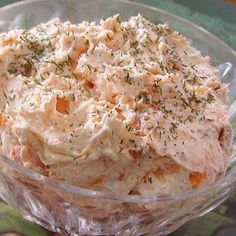 a bowl filled with mashed potatoes covered in herbs