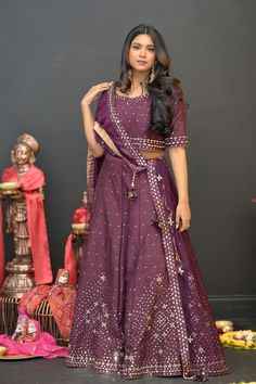 Plum Purple mirror work lehenga choli Matched with Purple mirror work blouse with quarter sleeves. Designed with round neck and has back hooks. Set together with a matching soft net purple duppata with mirror work and have gold border The length of the blouse is 14 inches. Blouse can fit a size 32 to 42 The maximum length of the lehenga will be 41 inches. Slight variation in color is possible due to digital photography. This is a 3 piece set. Care: dry clean only We provide side fitting/sleeves Purple Dola Silk Sharara With Gota Work, Purple Chanderi Lehenga For Reception, Purple Gota Work Dola Silk Sharara, Purple Chanderi Sharara For Reception, Purple Art Silk Sharara With Dori Work, Purple Art Silk Traditional Wear With Gota Work, Purple Chanderi Choli For Reception, Purple Chanderi Lehenga For Wedding, Purple Chanderi Choli With Resham Embroidery