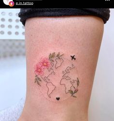 a woman's thigh with flowers and a world map tattoo on her left side