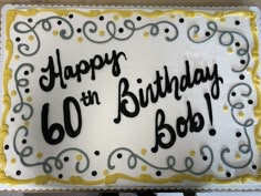 a birthday cake with the words happy on it's side and black writing that reads, 60 bob