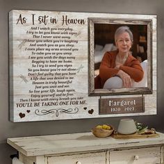 a wooden plaque with the words as i sit in heaven and an image of a woman