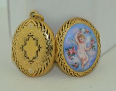 A very special 18K yellow gold locket. This locket dates from the 1880s (Victorian - Edwardian). It is crafted from 18K solid gold with lovely enamel work and a hand-painted scene. The locket features a hinged frame inside as well as a pop out frame with original glass for placing your favorite item in. The front of the locket features a hand-painted winged cherub in the clouds with roses surrounding it. The outer rim of the locket is done in black enamel work to give a very three-dimensional lo Gold Enamel Locket Jewelry, Gold Enamel Jewelry With Locket, Victorian Enamel Locket Jewelry, Antique Enamel Locket Jewelry, Luxury Enamel Locket Jewelry, Antique Gold Enamel Jewelry, Ceremonial Gold Jewelry With Black Enamel, Hinged Frame, Gold Locket