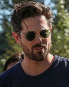 a man wearing sunglasses and looking at the camera