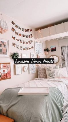 a bed room with a neatly made bed and lots of pictures on the wall above it