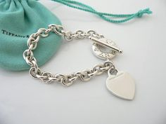 Overview:Offered for sale is a wonderful and gorgeous Tiffany & Co. Sterling Silver Heart Toggle bracelet.  Definitely a Tiffany piece that you will get your money's value for.  It works perfectly with pretty much any attire your put on, AND is a great statement piece.  The chain for this specific bracelet is quite substantial, and the pretty Tiffany heart just goes perfectly with it.   It is the perfect bracelet that fits a lifestyle on the go -- can be worn to pretty much any occasion! Sterling Silver Tiffany, Sterling Silver Bracelets Women Tiffany & Co., Pink Tiffany And Co Charms, Tiffany Charm Bracelets Tiffany & Co., Tiffany Inspired Jewelry Sterling Silver, Elegant Heart Bracelet With Toggle Clasp For Valentine's Day, Luxury Silver Heart Bracelet For Valentine's Day, Luxury Sterling Silver Bracelets For Valentine's Day, Luxury Valentine's Day Charm Bracelet