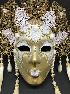 Venetian Mask for decoration - Traditional and original papier-mache Venetian mask, handmade and decorated with metal insert, gold-leaf and glitters, enriched with Swarovski crystals. Dimension::Hight 35cm,width 28cm Decoration only,not wereable All our masks are handmade paper-machè masks made in Venice. Our decorators use techniques typical of the Venetian tradition such as stucco, acrylics, gold and silver-leaf, macramè, passementerie, glitters and crequelè to offer you a wide range of origin Paper Mache Mask, Venice Mask, Venetian Carnival, Venetian Mask, Original Dolls, Costume Masks, The Venetian, Costume Mask, Photo Mask