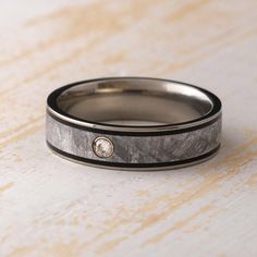 a close up of a wedding ring with a diamond on the inside and in the outside