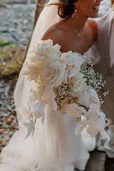 the bride and groom are walking down the street