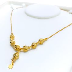 Weighing 8.9 grams, this lovely 21k gold necklace exudes ethereal beauty with its radiant yellow gold finish. The 18-inch length provides an elegant fit, while the 1-inch drop adds a subtle, graceful touch. Secured with a lobster lock, this piece blends timeless charm with modern sophistication, making it perfect for special occasions or everyday wear. Its delicate design offers a refined and lasting elegance. PRODUCT DETAILS Gold Purity(karat): 21k Gold Weight(grams): 8.9 Item Finish: Yellow Go Elegant Gold-plated Gold Necklace, 22k Gold Elegant Necklaces, Elegant Yellow Gold Plated Necklaces, Elegant Gold Necklace With Delicate Chain, Yellow Gold Plated Long Drop Necklace, Elegant 22k Gold Pendant Necklace, Elegant 22k Gold Chain Necklace, Elegant 22k Yellow Gold Necklace, Indian Rings