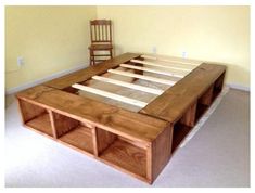 a wooden bed frame sitting in the middle of a room