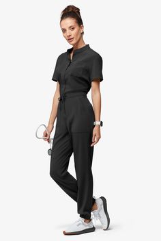 Now, this is modern. A jumpsuit! No easier way to get dressed – nothing to match and your top stays tucked in. Ours is so cute – a drawstring to add shape plus six functional pockets. The Easy Stretch Collection is designed for a modern look and easy fit. 4-way stretch performance fabric keeps you comfortable all shift long. • Modern fit • Open placket neckline • Concealed full-length front zipper • Drawstring waist • Total of 6 pockets • 2 roomy front patch pockets • 1 cellphone pocket • 2 back Scrub Style, Dickies Scrubs, Jumpsuit Outfits, Short Sleeve Jumpsuit, Mens Scrubs, Scrub Jackets, Easy Stretches, Tall Pants, Work Uniforms