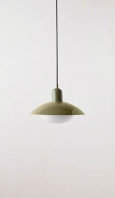 a green and white light hanging from a ceiling fixture in a room with no walls