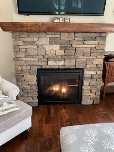 a living room with a fireplace and tv above it