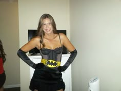 a woman in a batman costume posing for the camera