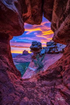 the sun is setting over some rocks and canyons in this photo, looking out into the distance