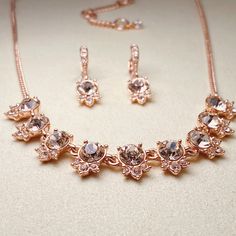 "A mix of clear and colored crystals decorate this exceptional set, complete with a stunning collar necklace and pair of drop earrings.  Fashioned in rose gold-tone mixed metal.  Approximate necklace length: 16\" + 3\" extender.  Approximate crystal drop: 1/2\".  Approximate earring drop: 1\". Original GIVENCHY box" Crystal Rhinestone Jewelry Sets For Gifts, Crystal Jewelry Sets With Diamond Accents For Gift, Sparkling Crystal Jewelry Sets For Gift, Crystal Jewelry Sets With Sparkling Stones For Anniversary, Anniversary Jewelry Sets With Sparkling Crystal Stones, Anniversary Jewelry Sets With Sparkling Crystals, Costume Jewelry Crystal Sets With Matching Earrings, Crystal Jewelry Sets With Sparkling Stones In Costume Style, Crystal Jewelry Sets With Sparkling Stones For Costume