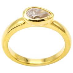 This stunning and classic diamond ring is set in 18K yellow gold and the diamond size is approx. 0.62 carats. The side setting of the tear drop diamond is elegant and artistic as it sings of individuality and is made to perfection in a traditional bezel setting. The band is thick and substantial. Great for stacking and brilliant by itself. Color I, Clarity SI2. The ring is a size 6 1/4 and can be sized to fit your finger. Yellow Gold Teardrop Diamond Ring With Rose Cut Diamonds, Teardrop Rose Cut Diamond Ring In Yellow Gold, Teardrop Diamond Ring With Single Diamond For Anniversary, Formal Teardrop Ring With Single Cut Diamonds, Yellow Gold Pear-shaped Rose Cut Diamond Wedding Ring, Pear-shaped Diamond Ring With Bezel Setting, Heirloom Teardrop Diamond Ring For Formal Occasions, Formal Heirloom Teardrop Diamond Ring, Gold Diamond Ring With Rose Cut Teardrop Diamonds