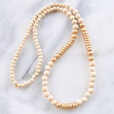 With a mix of whitewash and gold wood beads and in an easy pull-over-the-head style, this limited edition wood bead necklace is sure to dress up...well, anything! 8mm whitewashed and gold painted wooden beads gold-plated crimp with bead closure 28 inches long all Libby & Smee necklaces come packaged in a clear resealing bag for storage Wood Bead Necklace Boho, Wooden Beads Necklace, Stretch Beaded Bracelets Diy, Wood Beads Jewelry, Wooden Bead Necklace, Wooden Bead Necklaces, Head Style, Beaded Necklace Diy, Wood Bead Necklace