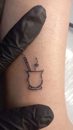 a woman's leg with a tattoo on it that has a mortar and pepper shaker in it