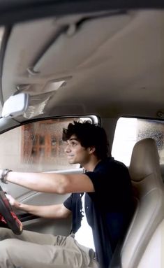 a man sitting in the driver's seat of a car