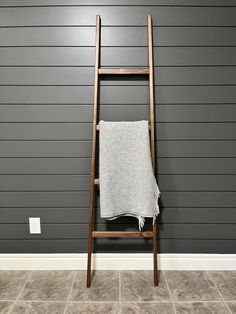 the "koselig" blanket ladder a beautiful minimalist modern style blanket ladder made from solid hardwood. designed with a subtle slope to the vertical members for added visual appeal the clean line aesthetic allows the warmth of the natural wood tones and grain patterns to lead. it's dimensions are 20" wide at the bottom and it's height is 72". if you like the style but require custom dimensions, please contact and we can arrange this to meet your needs. this blanket ladder comes fully assembled with solid wood joinery (no fasteners). ready to use immediately and built to last. finished with a penetrating oil finish to bring out all of the character the wood has to offer. each ladder is handmade from kiln dried premium hardwood; grain patterns and tones will vary. a variety of wood options Modern Blanket Ladder, Farmhouse Blanket Ladder, Farmhouse Blanket, Line Aesthetic, Modern Blanket, Farmhouse Blankets, Modern Blankets, Blanket Ladder, Wood Joinery