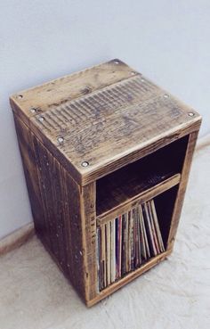 an old wooden record player box with vinyl records in it's storage compartment on the floor