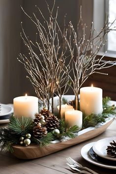 christmas centerpiece with candles, pine cones and greenery on a wooden platter