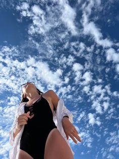 a woman in a black swimsuit is flying through the air