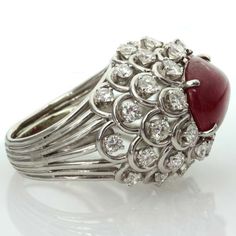 For Sale on 1stdibs - This captivating ring from David Webb features an open-design dome crown prong-set with an oval 11.0mm x 15.0mm cabochon ruby and surrounded by 36 sparkling Luxury Ruby Cabochon Diamond Ring, Luxury Oval Cabochon Ruby Ring, Luxury Silver Ruby Cabochon Ring, Luxury Ruby And Diamond Oval Cabochon Ring, Luxury Ruby Ring Oval Cabochon Polished Finish, Luxury Ruby Ring Oval Cabochon With Polished Finish, Luxury Ruby Ring With Oval Cabochon Diamond, Luxury Ruby Ring With Oval Cabochon And Polished Finish, Elegant Ruby Ring With Oval Diamond